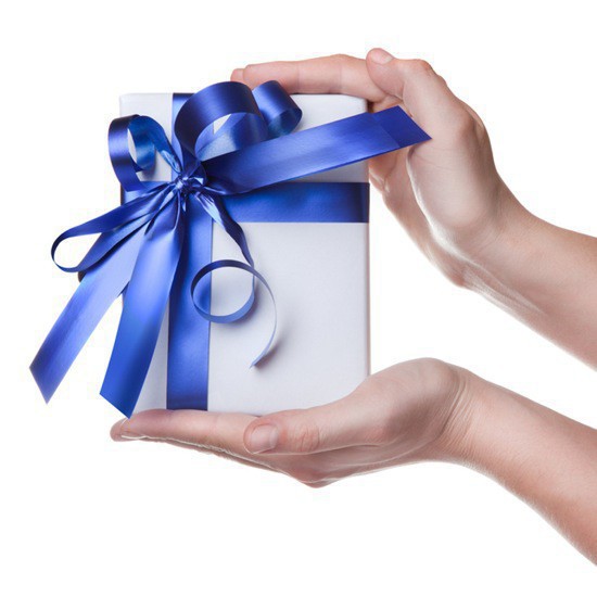 Hands holding gift in package with blue ribbon isolated on white